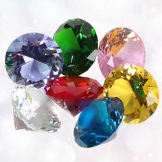 five different colored diamonds on a white surface