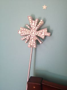 a decorative pinwheel on top of a dresser in a blue room with white stars