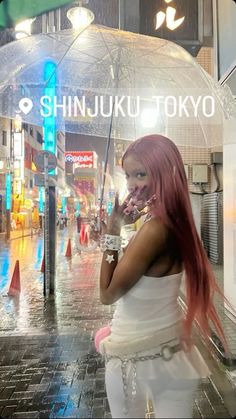 a woman with pink hair is holding an umbrella