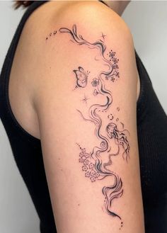 a woman's arm with a tattoo on it that has an image of a dragon and flowers