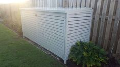 a white fence next to a green lawn