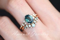 This amazing mermaid sapphire has an unbelievable opaque blue green color, It is a gorgeous looking and the way it sparkles is a complete attention catcher. It's set in a cluster setting with asymmetrical white VS diamonds on either side. The ring also has a matching band whose details are here in this listing: https://www.etsy.com/listing/1039699526/montana-sapphire-ring-sapphire-wedding. It is our recommended band.You can order this ring in 14K yellow, rose or white gold.Main stone: Natural me Mermaid Engagement Ring, Mermaid Sapphire, Sapphire Engagement Ring Unique, Teal Sapphire Ring, Ring Blue Sapphire, Montana Sapphire Ring, Blue Sapphire Engagement Ring, Teal Sapphire, Engagement Ring Unique