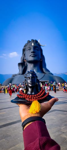 a person holding up a statue in their hand