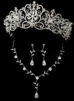 Regal Wedding or Quinceanera Tiara Set Make a glamorous statement on your special day with this gorgeous t iara and jewelry set! Tiara: This absolutely regal bridal tiara with its decorative floral design covered in dazzling rhinestones will add grandeur to your special day. This 2 1/2" filigree design tiara will make a fabulous headpiece for your royal inspired or classic wedding. Size: 17" Total Band Length, 11 1/2" Design Length, 2 1/2" Height. Color: Silver. Style: hp18693. Jewelry Set: This Writing Struggles, Beaded Watches Bracelet, Winter Wedding Accessories, Regal Wedding, Quinceanera Tiaras, Hair Accessories Tiara, Coordinates Jewelry, Tiara Wedding, Prom Accessories