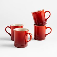 three red coffee mugs sitting next to each other