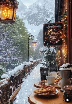 a table topped with plates of food next to a window covered in snow and lights