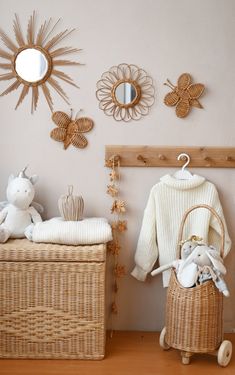 there is a wicker basket with stuffed animals in it next to a wall decoration