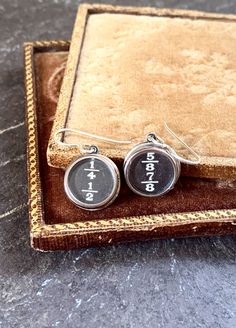 two personalized cufflinks are sitting in a box