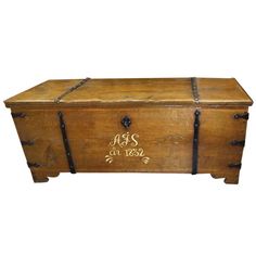 an old wooden chest with writing on it