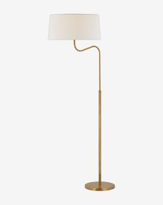 a gold floor lamp with a white shade