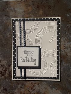 a happy birthday card with a clock on the front and black ribbon around the edges