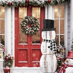 a snowman standing in front of a red door