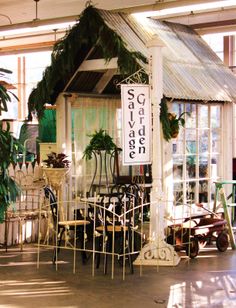 a store with lots of chairs and tables in front of the building's glass doors