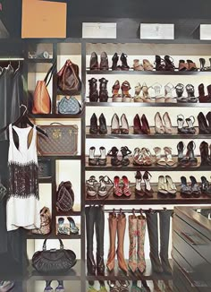 a closet filled with lots of shoes and purses next to a wall mounted shelf