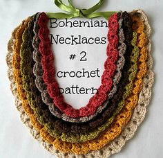 there are four crocheted necklaces on the table