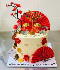 a cake decorated with money and red paper fans