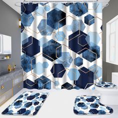 a bathroom with blue and white decor on the shower curtain, rugs and bath mats