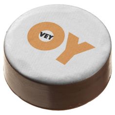 a white and brown object with the word yo on it's side, sitting in front of a white background