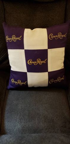 a black chair with a purple and white pillow on it