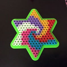 a star shaped object made out of plastic beads