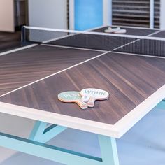 a ping pong table with two paddles on it