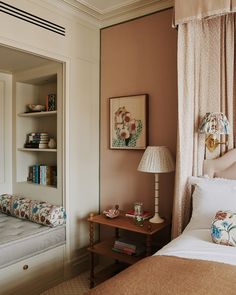 a bedroom with a bed, nightstand and mirror in the corner next to a window