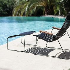 a lounge chair sitting next to a swimming pool