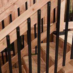 wooden stairs with black railings and handrails