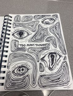 a spiral notebook with the words too many thoughts written on it and an image of two eyes