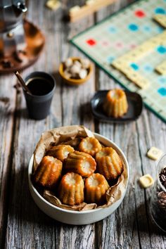 a bowl filled with food sitting on top of a wooden table next to a game