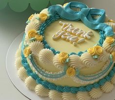 a birthday cake decorated with blue and yellow icing