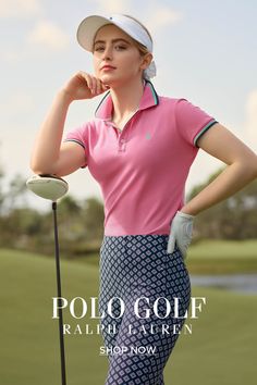 a woman in pink shirt and blue pants holding a golf club