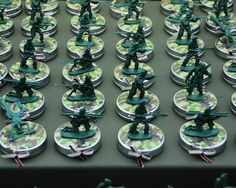 many toy soldiers are on small round trays with green and white designs in them