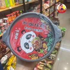 a person holding up a paper plate in a store