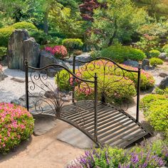 a garden with flowers, rocks and a metal bed in the middle is shown from above