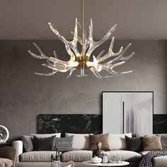 a living room filled with furniture and a chandelier hanging over the top of it