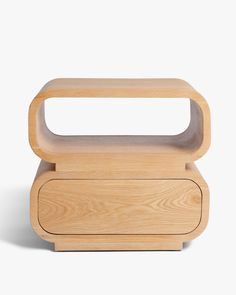 a small wooden box with a handle on the top and bottom, sitting on a white surface