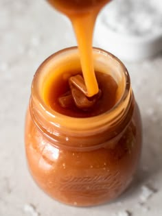 a jar filled with liquid sitting on top of a table