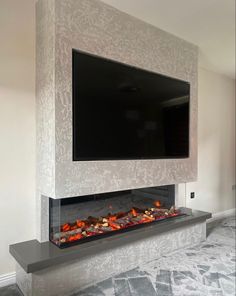 a flat screen tv mounted above a fireplace