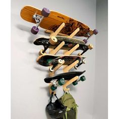 there is a skateboard hanging on the wall with other skateboards and gear attached to it