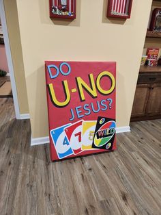 a sign that says do u - no jesus? on the floor in front of a wall