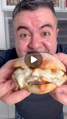 a man is eating a sandwich with cheese and meat on it, while making a funny face