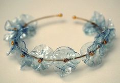 a close up of a headband made out of glass beads and gold metal wire