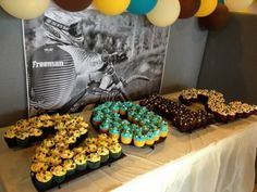 a table topped with lots of donuts and cupcakes