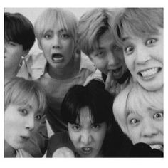 black and white photo of group of young people with mouths open in front of the camera