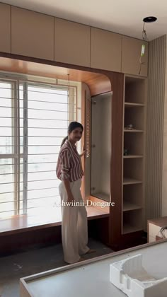 a woman standing in front of a mirror