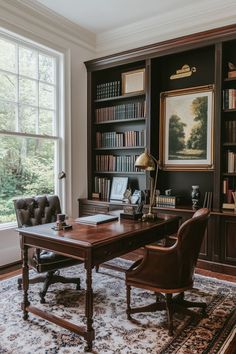 a home office with an old fashioned desk and leather chair in front of a large window