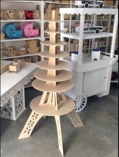 a wooden christmas tree sitting on top of a table in a room filled with toys