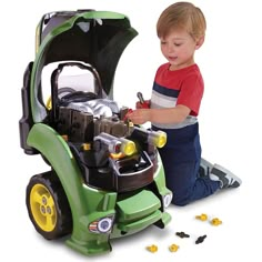 a young boy playing with a toy engine