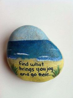 a painted rock with the words find what brings you joy and go free